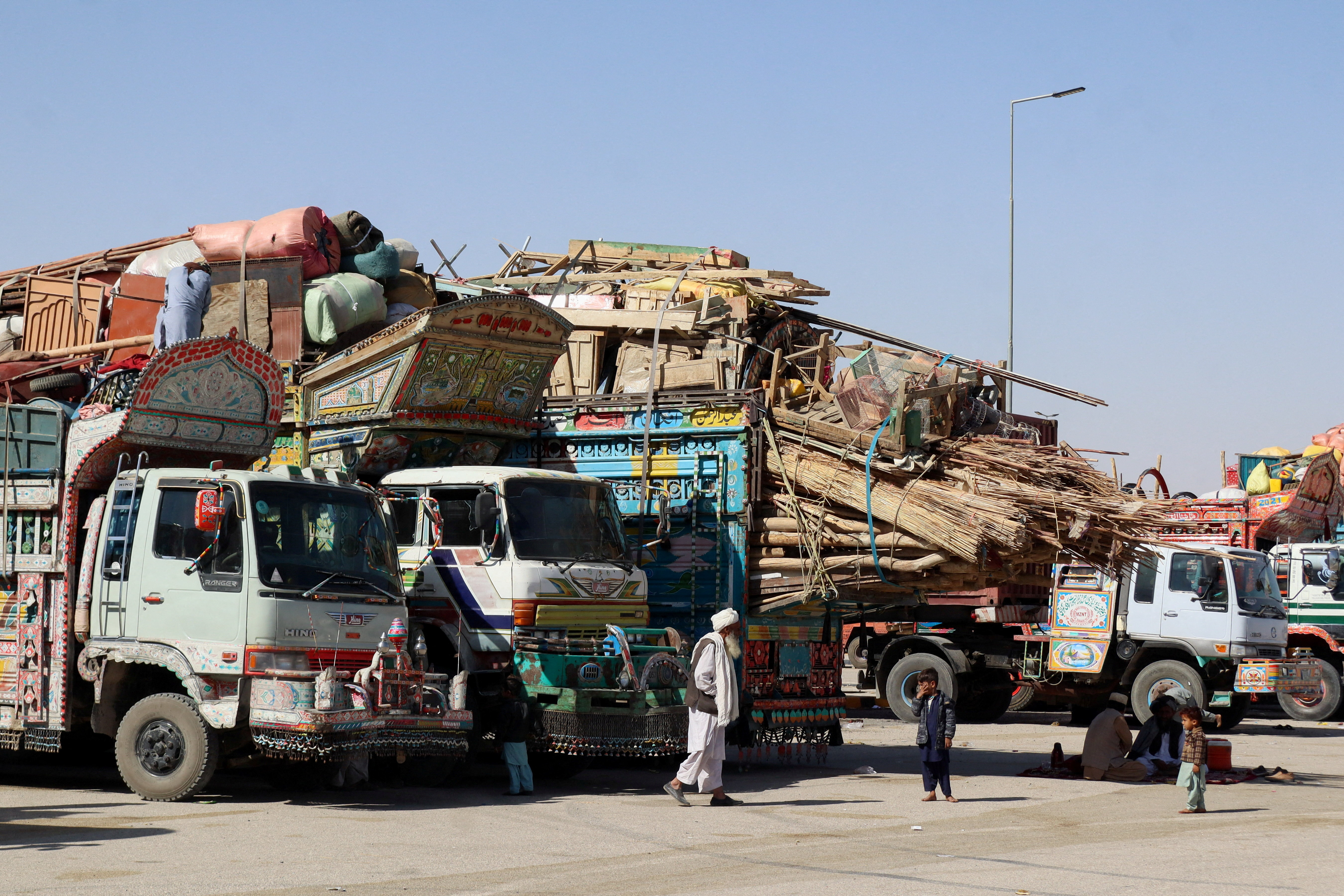 Residents ride a loaded truck of belongings, as they flee the area, following exchanges of fire between Pakistan and Afghanistan forces, at the border crossing in Chaman, Balochistan province, Pakistan, October 15, 2025. (REUTERS)